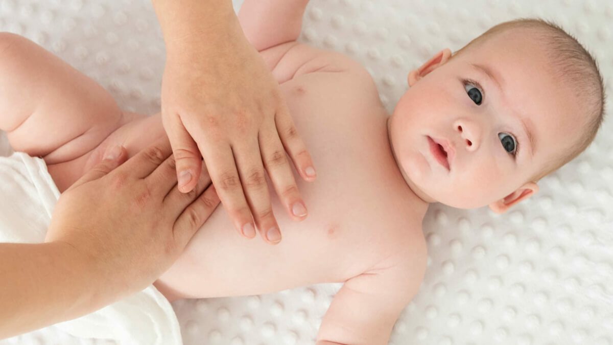 baby with hands on stomach