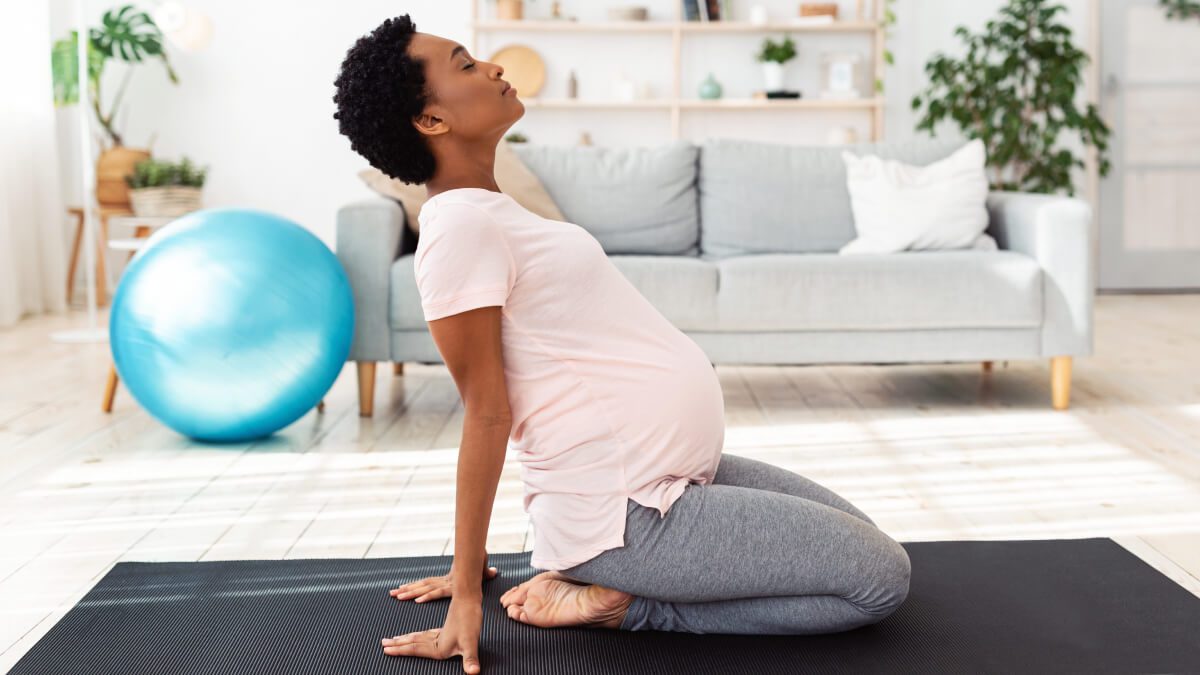 Pregnant woman on exercise mat