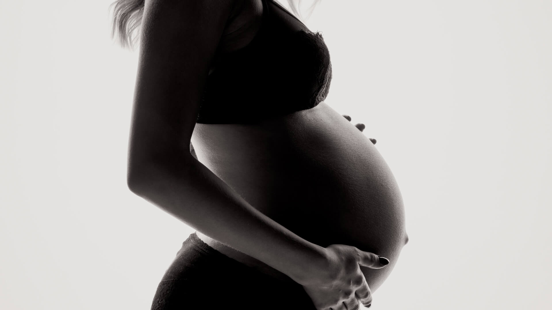 pregnant woman holding belly