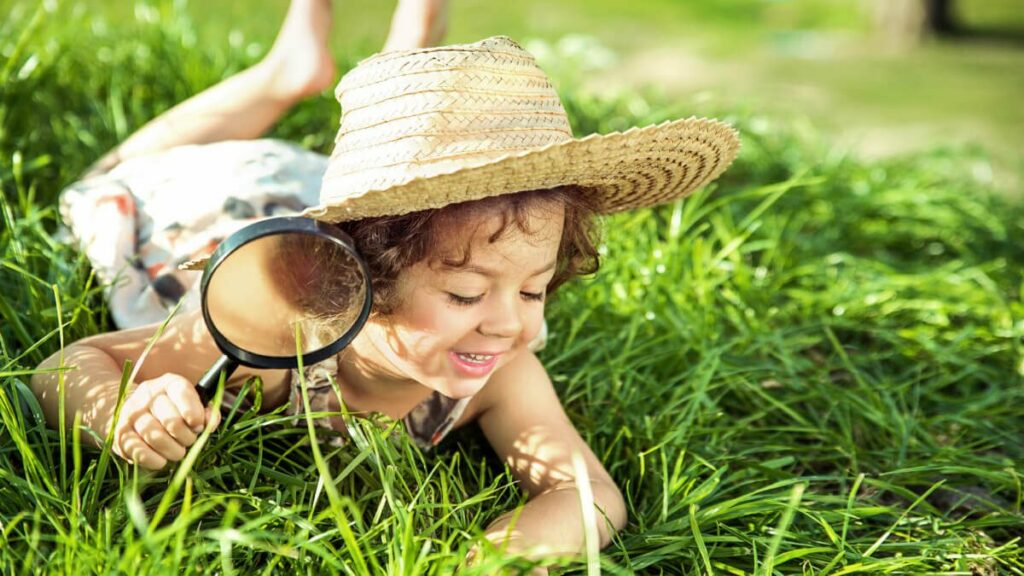 child playing in grass