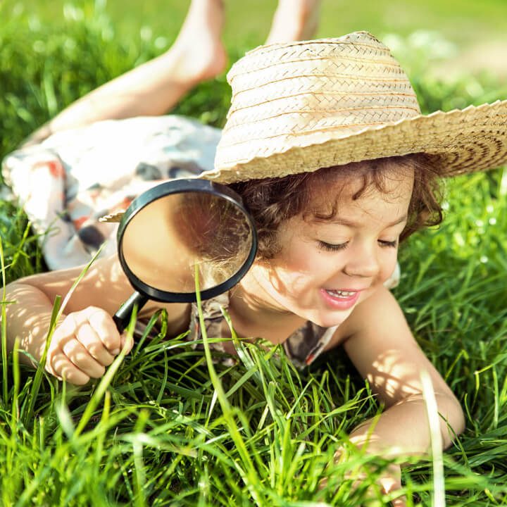 child playing in grass