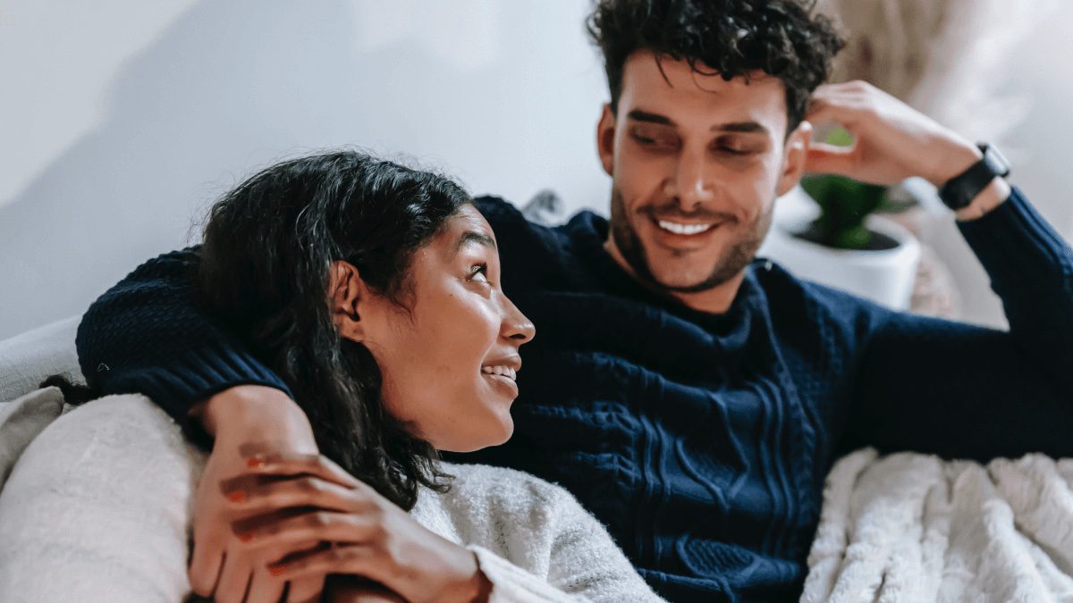 happy couple sitting on couch
