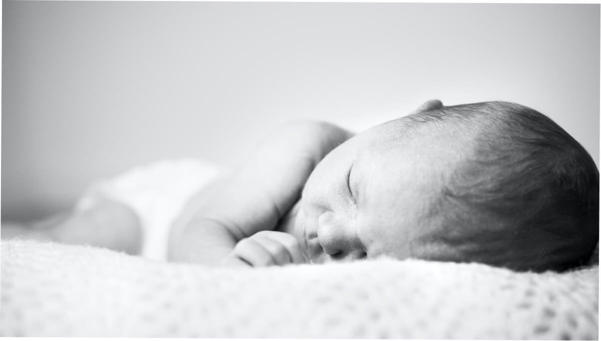 Baby sleeping on bed