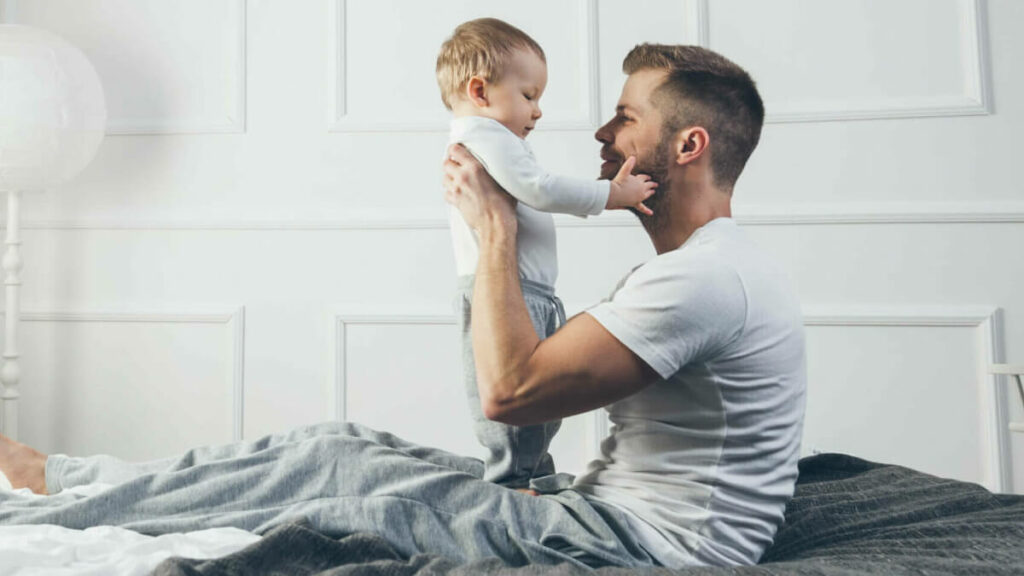 baby cuddling with father
