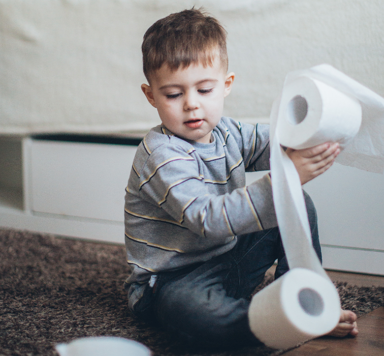 Young boy with toilet rolls 