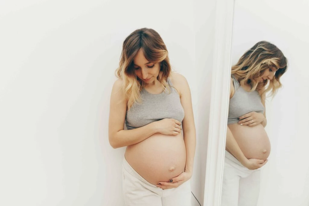 pregnant woman cradling bump